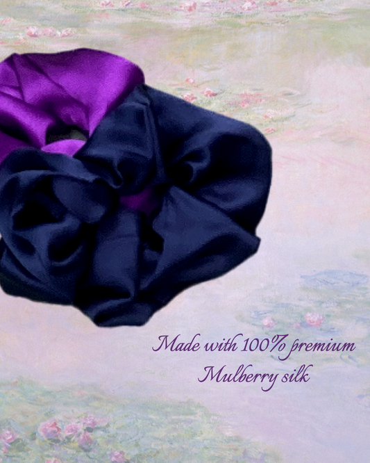 Two luxurious mulberry silk scrunchies in Royal Purple and Midnight Navy colors, displayed together on a textured background. The image emphasizes that they are made with 100% premium Mulberry silk, highlighting the high quality and soft texture.