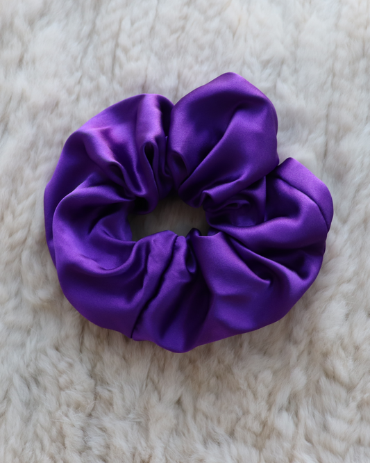 Single top-down view of a Royal Purple mulberry silk scrunchie, highlighting its smooth, luxurious folds and vibrant deep color. Perfect for all hair types.