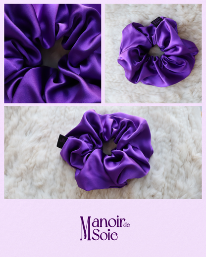 Close-up collage featuring a Royal Purple mulberry silk scrunchie, highlighting its smooth, elegant fabric and discreet brand tag. Includes a top view on a soft surface and a detailed fabric shot, with the "Manoir de Soie" logo below.
