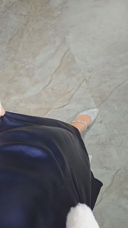 Video demonstrating the Midnight Navy mulberry silk maxi dress, focusing on the lower half as the fabric swings fluidly, showcasing its luxurious drape and elegant movement. The video highlights how the dress gracefully flows with every step.